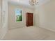 Bright bedroom featuring neutral walls, plush carpet, and a large window with decorative shutters at 2175 Sandstone Cliffs Dr, Henderson, NV 89044