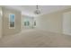 Spacious carpeted bedroom featuring decorative crown moulding and bright windows with shutters at 2175 Sandstone Cliffs Dr, Henderson, NV 89044