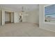 Spacious carpeted bedroom with a view to the ensuite bathroom and featuring decorative crown moulding at 2175 Sandstone Cliffs Dr, Henderson, NV 89044