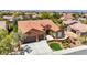 Expansive aerial view of this residence showcases meticulous landscaping, a terracotta roof, and a spacious three-car garage at 2175 Sandstone Cliffs Dr, Henderson, NV 89044