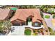 Beautiful terracotta roof home with great curb appeal showcases an inviting front yard and a three-car garage at 2175 Sandstone Cliffs Dr, Henderson, NV 89044