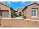 Close up of the home's terracotta roof, iron gate and desert landscaping at 2175 Sandstone Cliffs Dr, Henderson, NV 89044