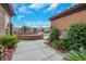 View of the front entrance and side yard with drought-tolerant landscaping at 2175 Sandstone Cliffs Dr, Henderson, NV 89044