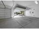 Spacious two-car garage with an open door offers a glimpse of the lovely neighborhood beyond at 2175 Sandstone Cliffs Dr, Henderson, NV 89044