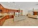 Open kitchen with stainless steel appliances, center island, and granite countertops at 2175 Sandstone Cliffs Dr, Henderson, NV 89044