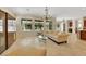 Spacious living room featuring large windows, tile floors and decorative chandelier at 2175 Sandstone Cliffs Dr, Henderson, NV 89044
