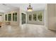 Bright living room featuring tile floors, large windows, and elegant chandelier at 2175 Sandstone Cliffs Dr, Henderson, NV 89044