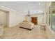 Spacious living room featuring large windows, tile floors, and kitchen in the distance at 2175 Sandstone Cliffs Dr, Henderson, NV 89044