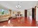 Bright living room featuring wood floors, comfortable seating, and a stylish chandelier at 2175 Sandstone Cliffs Dr, Henderson, NV 89044