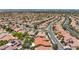 Areal shot of a neighborhood of terracotta roof houses creates an aesthetically pleasing view of community living at 2175 Sandstone Cliffs Dr, Henderson, NV 89044