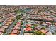 Aerial shot of a community with terracotta roofs, tree-lined streets, and carefully manicured lawns creates neighborhood appeal at 2175 Sandstone Cliffs Dr, Henderson, NV 89044