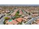 Overhead shot of a vibrant suburban neighborhood with terracotta-roofed homes and lush greenery throughout the community at 2175 Sandstone Cliffs Dr, Henderson, NV 89044