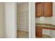 Walk-in pantry with desk and wooden cabinets at 2175 Sandstone Cliffs Dr, Henderson, NV 89044
