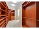 Large walk-in closet with custom wood shelving and closet organizers at 2175 Sandstone Cliffs Dr, Henderson, NV 89044