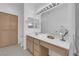 Bright bathroom with a vanity, large mirror, bright vanity lighting, and natural-colored cabinets with plenty of storage at 2323 Barbers Point Pl, Las Vegas, NV 89134