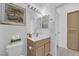Well-lit bathroom featuring a vanity, mirror, toilet, linen closet, and neutral decor at 2323 Barbers Point Pl, Las Vegas, NV 89134