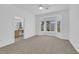 Bright bedroom with neutral carpet and bay windows with view to the outside at 2323 Barbers Point Pl, Las Vegas, NV 89134
