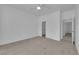 Bedroom with neutral carpet, a ceiling fan, closet with sliding doors, and an open doorway to the rest of the house at 2323 Barbers Point Pl, Las Vegas, NV 89134