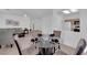 Bright dining area featuring a glass table and view into a living area with neutral decor and tile flooring at 2323 Barbers Point Pl, Las Vegas, NV 89134