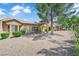 Charming single-story home featuring manicured landscaping, neutral tones, and desert landscaping at 2323 Barbers Point Pl, Las Vegas, NV 89134