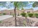 Inviting single-story home with a two-car garage and drought-tolerant desert landscaping at 2323 Barbers Point Pl, Las Vegas, NV 89134