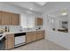 Kitchen featuring light wood cabinets, tile floors and a white countertop with stainless appliances at 2323 Barbers Point Pl, Las Vegas, NV 89134