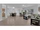Spacious living room with tile flooring, large windows, and a cozy seating area at 2323 Barbers Point Pl, Las Vegas, NV 89134