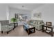 Comfortable living room showcasing tile floors, a sectional sofa, and serene decor at 2323 Barbers Point Pl, Las Vegas, NV 89134