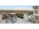Charming balcony with a dining set, framed by black railings and palm trees with a stunning view of the city at 2736 Botticelli Dr, Henderson, NV 89052