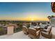 Elegant balcony with comfortable seating and a fire pit table, offering stunning views of the mountains and city at 2736 Botticelli Dr, Henderson, NV 89052