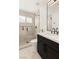 Modern bathroom features sleek black fixtures, bright lighting, and a glass-enclosed shower at 2736 Botticelli Dr, Henderson, NV 89052