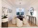 Formal dining room with modern light fixture, long dining table and comfortable seating at 2736 Botticelli Dr, Henderson, NV 89052