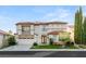 Charming two-story home with well-manicured lawn and a two car garage, framed by beautiful landscaping at 2736 Botticelli Dr, Henderson, NV 89052