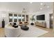 Bright and airy living room with large windows, modern furniture, a stylish chandelier, and an elevator at 2736 Botticelli Dr, Henderson, NV 89052