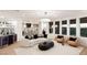 Open concept living room with a stylish bar area, modern furniture, and large windows offering scenic views at 2736 Botticelli Dr, Henderson, NV 89052