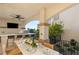 Inviting outdoor dining area with bar, television, ceiling fan, and views of the green foliage and city skyline at 2736 Botticelli Dr, Henderson, NV 89052