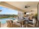 An outdoor patio with a pool, lounge furniture, outdoor kitchen, and scenic views at 2736 Botticelli Dr, Henderson, NV 89052