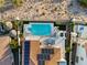 Aerial view of a backyard pool and patio with a clear blue pool and an outdoor seating area at 2736 Botticelli Dr, Henderson, NV 89052