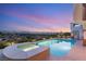 A sparkling swimming pool with spa, beautiful sky, and wrought iron fence around the property at 2736 Botticelli Dr, Henderson, NV 89052