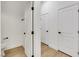 Hallway featuring white paneled doors with black hardware and wood flooring at 2921 Guillemot Ave, North Las Vegas, NV 89084