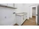 Well-lit laundry room featuring white cabinets and a doorway leading to a half bath at 2921 Guillemot Ave, North Las Vegas, NV 89084