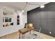 Modern home office featuring a decorative wall, sleek desk and chair, and views into the adjacent living space at 2921 Guillemot Ave, North Las Vegas, NV 89084