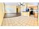 Open-concept kitchen with bar seating, tile flooring, cabinetry, and modern appliances at 3125 Prairie Princess Ave, North Las Vegas, NV 89081