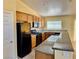 Well-appointed kitchen features granite countertops, tile flooring, and black appliances at 3125 Prairie Princess Ave, North Las Vegas, NV 89081