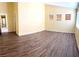 Bright living area featuring wood-look tile flooring, neutral walls, and a seamless flow to other rooms at 3125 Prairie Princess Ave, North Las Vegas, NV 89081