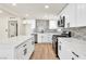 Bright kitchen showcases white cabinets, stainless appliances, and a spacious island at 3212 Hickey Ave, North Las Vegas, NV 89030