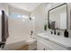 Bright bathroom featuring a tub, a modern sink, and stylish fixtures at 356 Gulfport Ct, Las Vegas, NV 89145