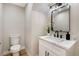 Powder room with modern vanity, marble countertop, and elegant black fixtures at 356 Gulfport Ct, Las Vegas, NV 89145