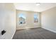 A bright, carpeted bedroom illuminated by natural light streaming through two windows at 356 Gulfport Ct, Las Vegas, NV 89145