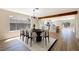Bright dining room with modern lighting, wood beam, and an open layout to the kitchen and backyard at 356 Gulfport Ct, Las Vegas, NV 89145